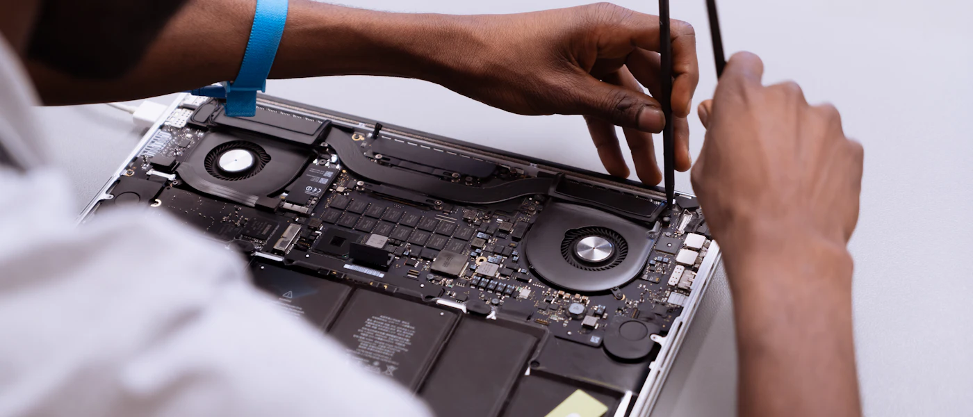 A technician repairing a laptop on-site